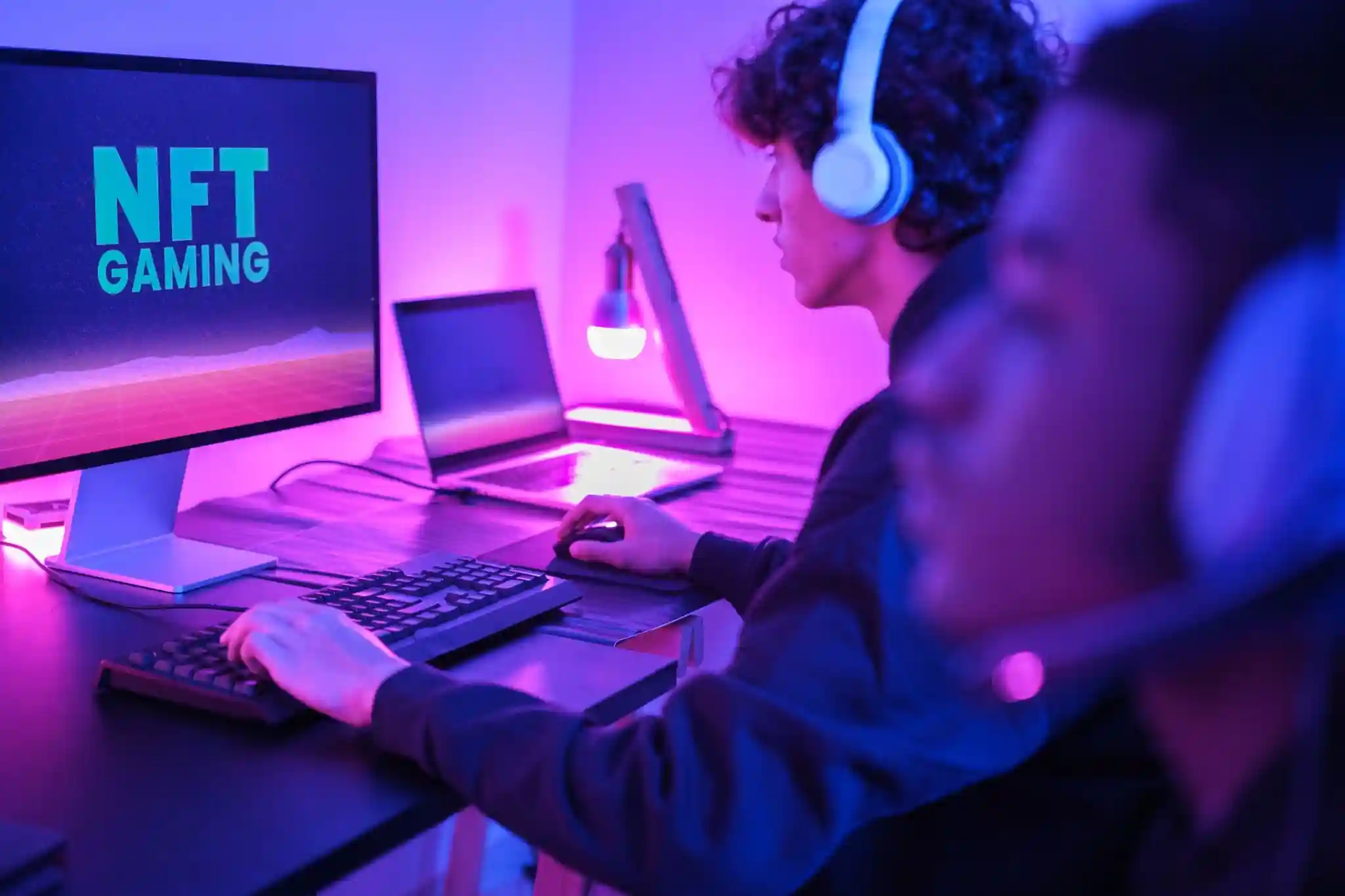 How do NFT games reward players with digital assets?